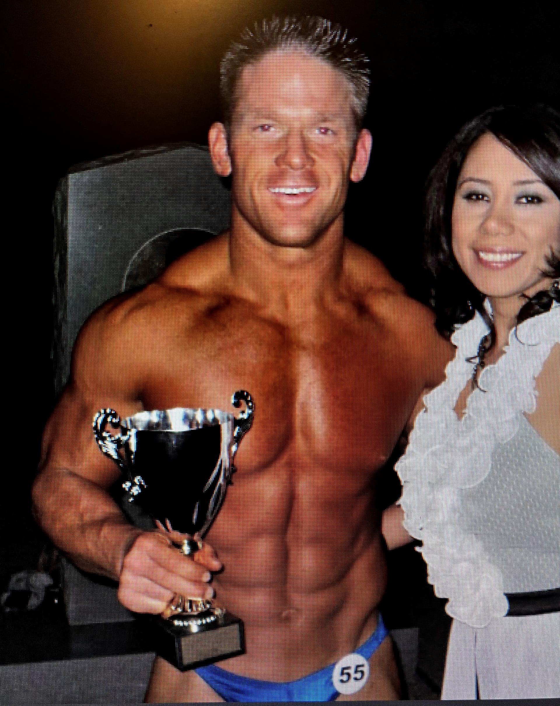 Garth Wotkyns holding his trophy at a bodybuilding competition