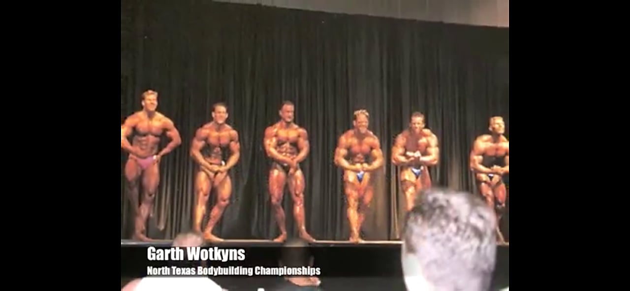 Bodybuilding competition lineup of athletes on stage